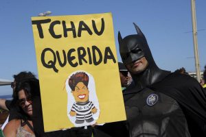 zzzzinte1A man disguised as Batman holds a sign reading "Bye Darling" during a protest in favor of impeachment of President Dilma Rousseff in Copacabana, Rio de Janeiro, Brazil on April 17, 2016. Rousseff risks being driven from office if the lower house votes in favor of an impeachment trial Sunday in Brasilia. / AFP PHOTO / TASSO MARCELOzzzz