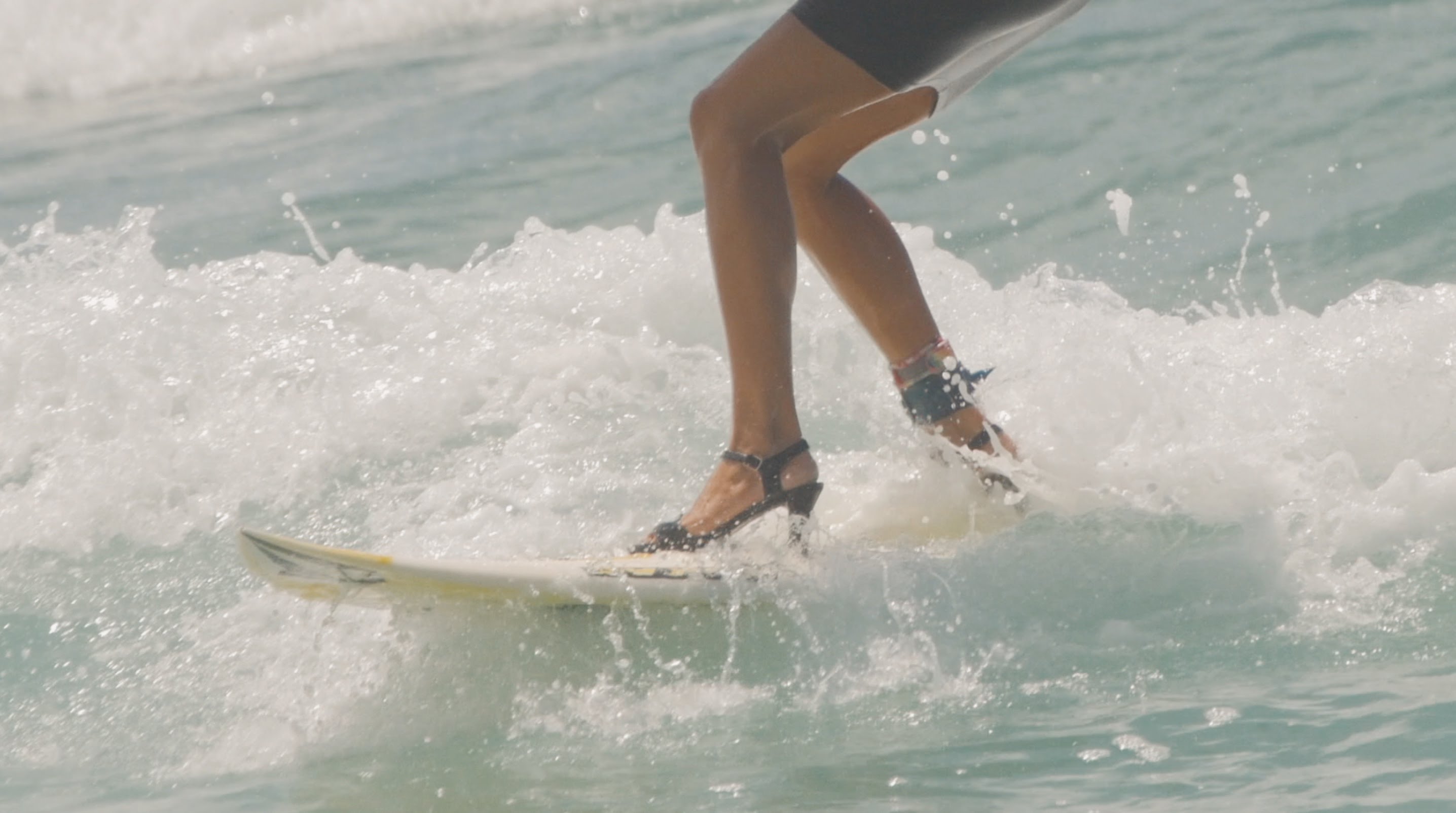 Bella y muy elegante domina las olas en su tabla de surf
