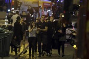 zzzzinte1TOPSHOTS Rescuers evacuate people following an attack in the 10th arrondissement of the French capital Paris, on November 13, 2015. At least 18 people were killed as multiple shootings and explosions hit Paris, police said. Police also said there was an ongoing hostage crisis in the Bataclan a concert hall in the French capital. AFP PHOTO / KENZO TRIBOUILLARDzzzz