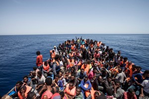 Migrants crowd the deck of their wooden boat off the coast of Libya May 14, 2015. International non-governmental organisations Medecins sans Frontieres (MSF) and MOAS (Migrant Offshore Aid Station) rescued 561 migrants at sea off the coast of Libya on Thursday, according to Maltese media. Their vessel, the Phoenix, is the first privately funded vessel to operate in the Mediterranean. Almost 3,600 migrants have been rescued from overcrowded boats sailing from Africa to Europe over the past 48 hours, Italy said on Thursday, with sea conditions seen as perfect for attempting the crossing. REUTERS/MOAS/Jason Florio/Handout via Reuters ATTENTION EDITORS - NO SALES. NO ARCHIVES. FOR EDITORIAL USE ONLY. NOT FOR SALE FOR MARKETING OR ADVERTISING CAMPAIGNS. THIS IMAGE HAS BEEN SUPPLIED BY A THIRD PARTY. IT IS DISTRIBUTED, EXACTLY AS RECEIVED BY REUTERS, AS A SERVICE TO CLIENTS TPX IMAGES OF THE DAY